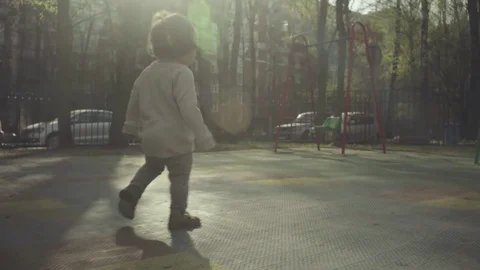 A kid walking in the courtyard Stock Footage 75777305