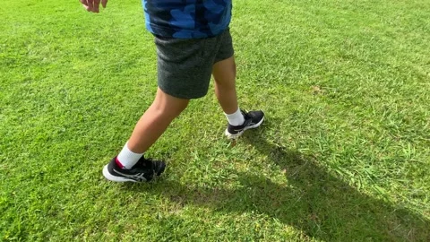 Kid walking on grass Video stock 143644343