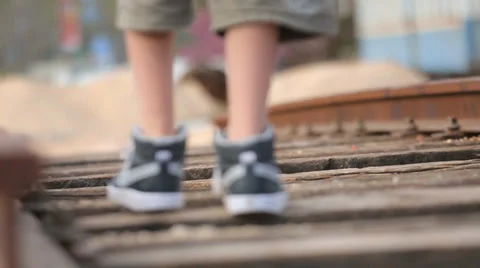 Kid walking on old train tracks Stock Footage 37557759