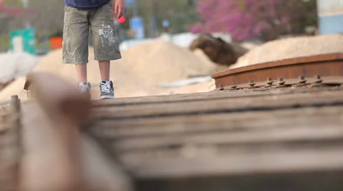 Kid walking on old train tracks Stock Footage 37557856