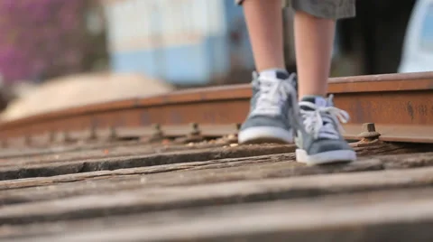 Kid walking on old train tracks Stock Footage 37558187