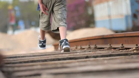 Kid walking on old train tracks Stock Footage 37558851
