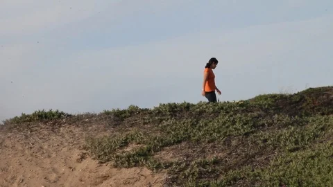 Kid walks down other side of hill Stock Footage 113911821
