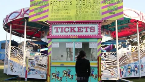 Kid walks up to empty ticket booth at fair Stock Footage 154939210