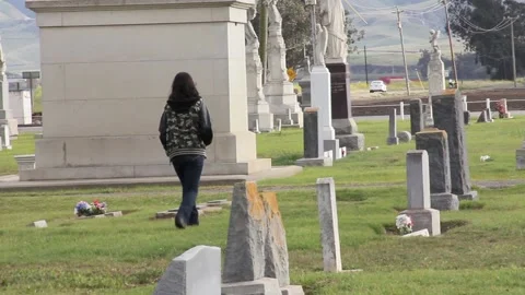 Kid walks thru graveyard Stock Footage 155327204