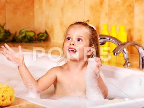 Kid washing in bath. Stock Photos