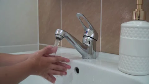 Kid washing hands in bathroom Stock Footage 213064986