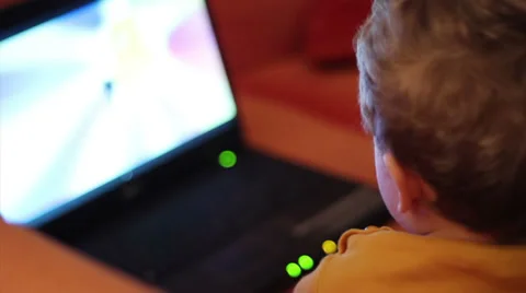Kid watching cartoon on notebook Stock Footage 33268914