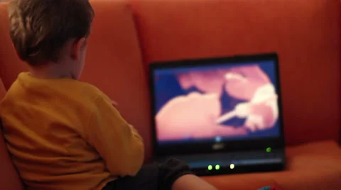 Kid watching cartoon on notebook Stock Footage 33269094