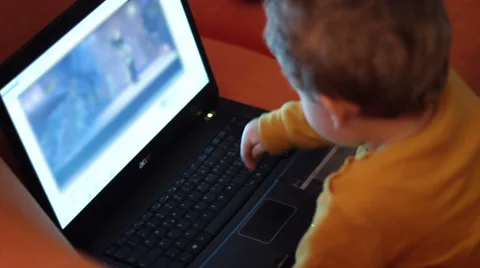 Kid watching cartoon on notebook Stock Footage 33270195