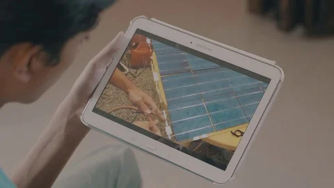 Kid watching electrical work DIY (Do It Yourself) video solution on tablet Stock Footage 73643805