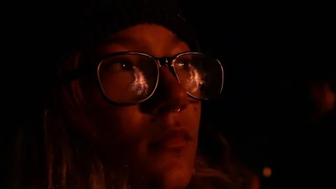 Kid watching fire, fire reflecting off glasses Stock Footage 122307157