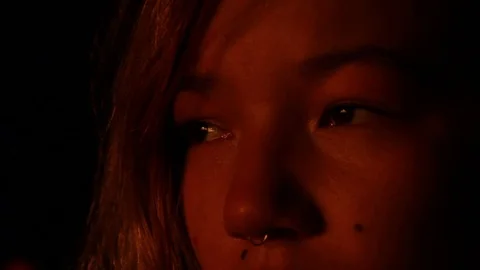 Kid watching fire, the heat reflecting on her face Stock Footage 122354929