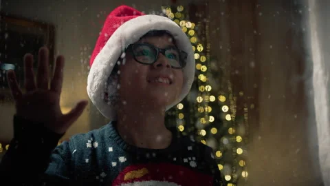 Kid watching outside window on rainy christmas night Stock Footage 255785035