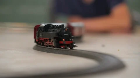 Kid watching Toy train shallow depth of field Stock Footage 37558821