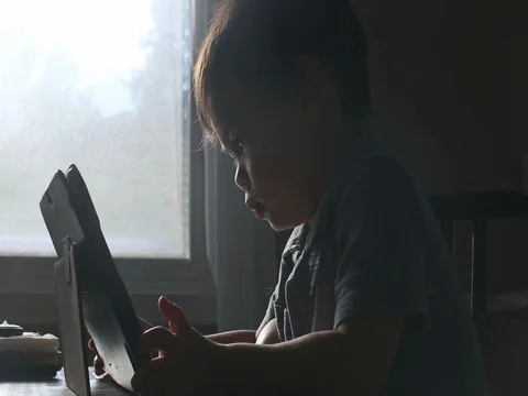 Kid watching video on tablet, video Видео 79720304
