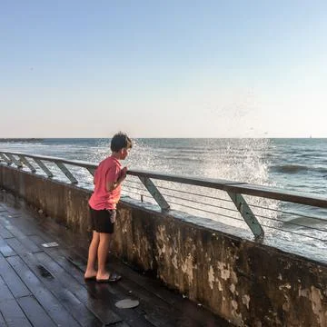 Kid watching the waves 写真素材