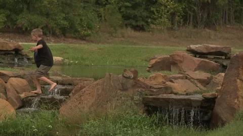 Kid on waterfall Stock Footage 916151