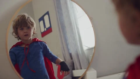 Kid Wearing Superhero costume looking in the mirror Stock Footage 279221753