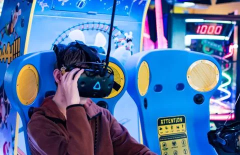 Kid while playing virtual reality game in an arcade game center Stock Photos
