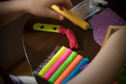 A Kid Working with Plasticine Stock Photos