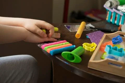 A Kid Working with Plasticine Stock Photos