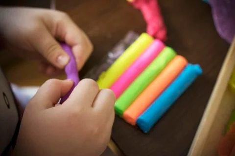 A Kid Working with Plasticine Stock Photos