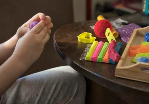 A Kid Working with Plasticine Stock Photos
