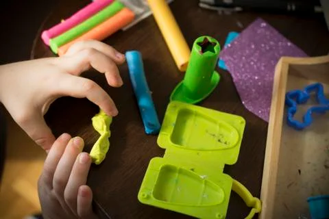 A Kid Working with Plasticine Stock Photos