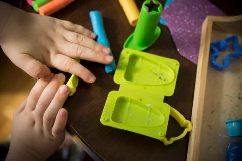 A Kid Working with Plasticine Stock Photos