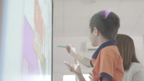 Kid is writing on interactive board Stock Footage 134230262