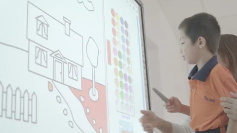 Kid is writing on interactive board Stock Footage 134230294