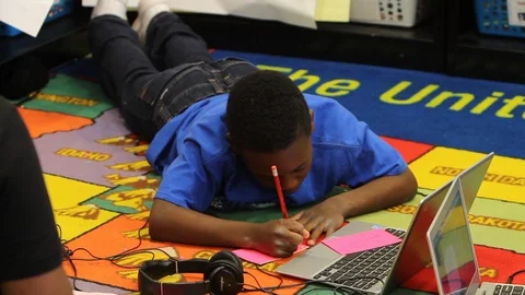 Kid writing notes from computer Stock Footage 92495771