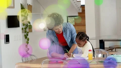 Kid writing at table, mom leaning guiding school with green pencil, overlays Stock Footage 333632110