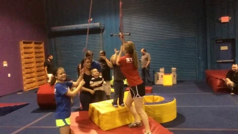 Kid ziplining to blue foam pit  Stock Footage 74475909
