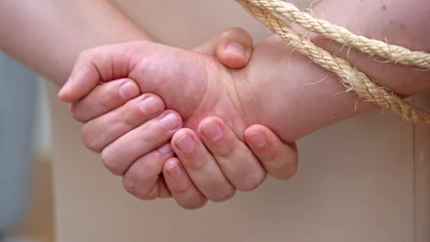 Kidnapper fastens hands of victim behind back failing to escape Stock Footage 258993488