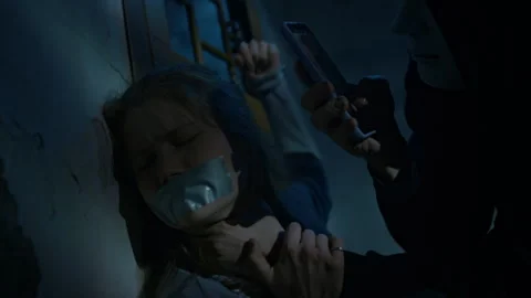 Kidnapper Keeping Young Lady Captive and Taking Photos on Phone Stock Footage 293696727