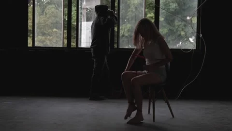 Kidnapper or Robber force gun point woman hostage and vdo call ransom. Stock Footage 209124595