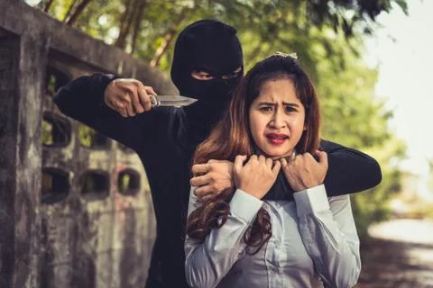 Kidnapper or Robber force knifepoint woman hostage to take off her clothes or Photos
