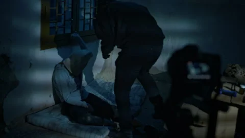Kidnapper Recording Video with Hostage in Basement Stock Footage 293699052
