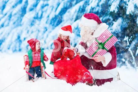 Kids and Santa with Christmas presents Stock Photos