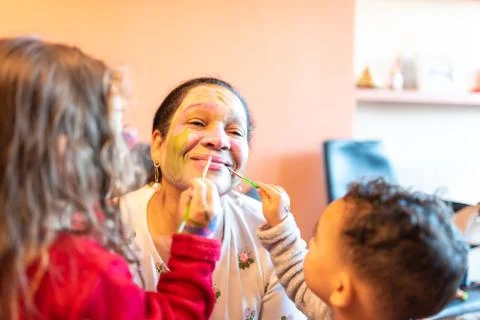 Kids applying make up to grandmother. Stock Photos