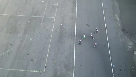 Kids are practicing roller skates with coach on the small circuits. 4k Stock Footage 247347757