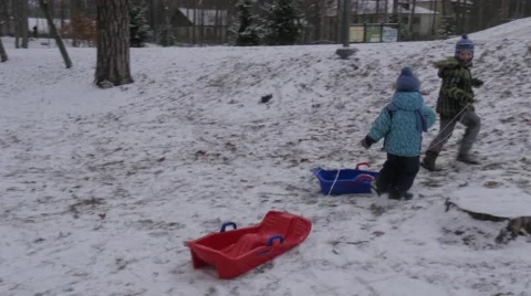 Kids Are Pulling up a Sleighs Running up the Hill Going to Ride Downhill Winter Stock Footage 59132260