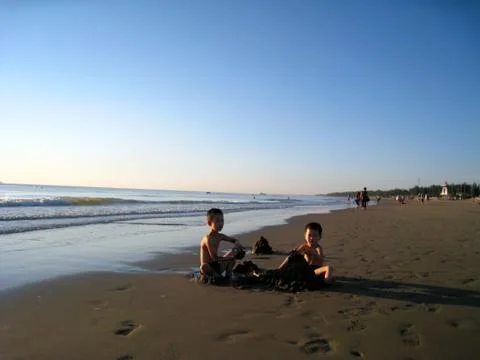 Kids bathing in the beach Stock Photos