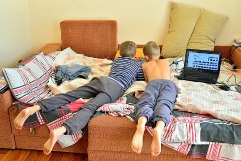 Kids in bed, playing computer Stock Photos