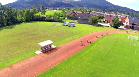 Kids on bicycle speeding down the track aerial shot 스톡 동영상 40675621