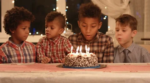 Kids blowing candles on cake. Stock Footage