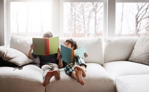 Kids, bonding reading books in education, learning or relax studying on house Stock Photos