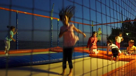 Kids bouncing on trampoline (Editorial) Stock Footage 30559390